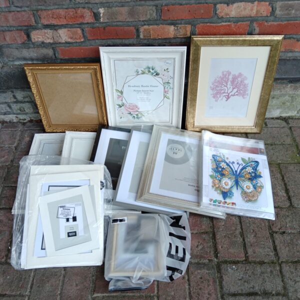 Mixed lot of diamond painting kits and picture frames for crafting.