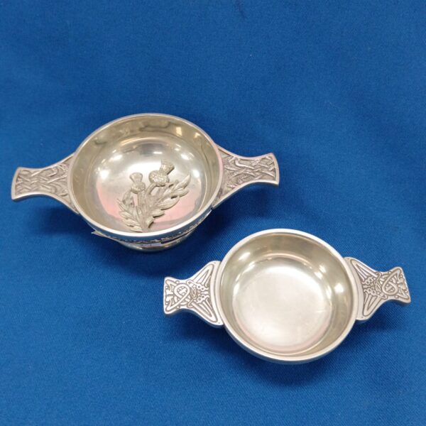 Antique pewter quaich cups with embossed floral design.