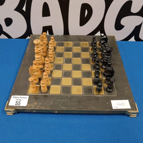 Vintage wooden chess set with brass inlay and carved pieces.