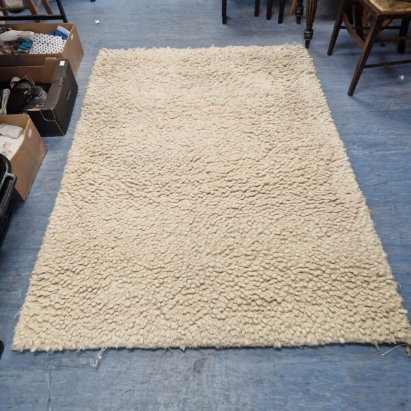 Large neutral shag pile rug from John Lewis.