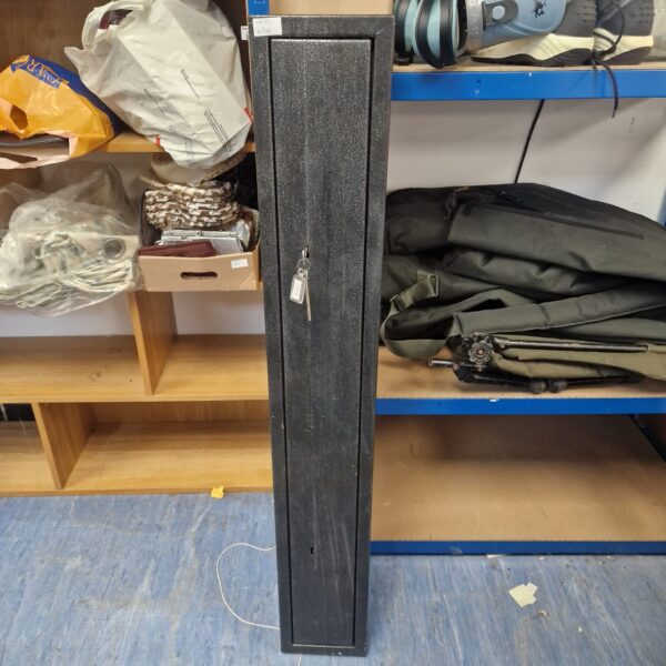 Front view of a tall, black gun safe with a keyed lock.