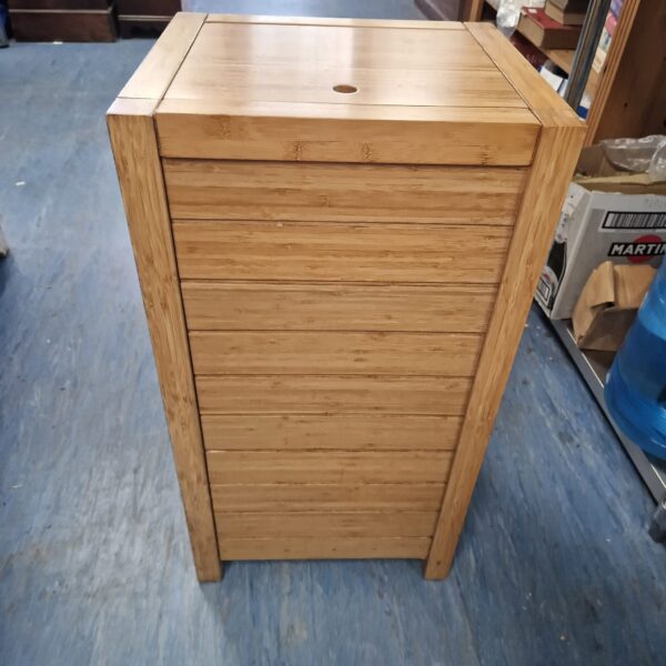 Front view of a rustic wooden wash bin for laundry storage.