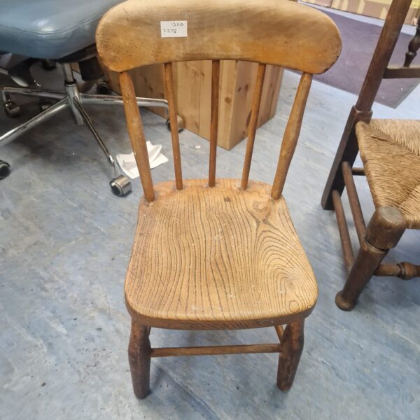 Vintage wooden childs chair with shaped back.