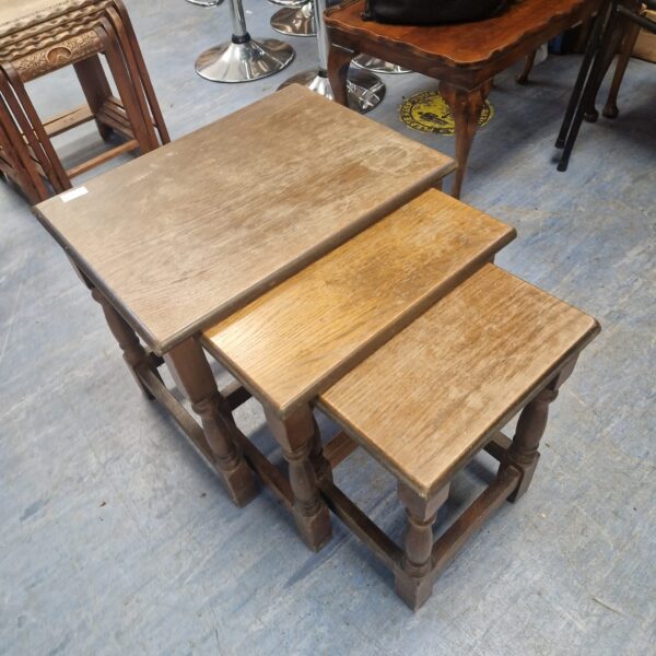 Vintage wooden nest of tables with turned legs.