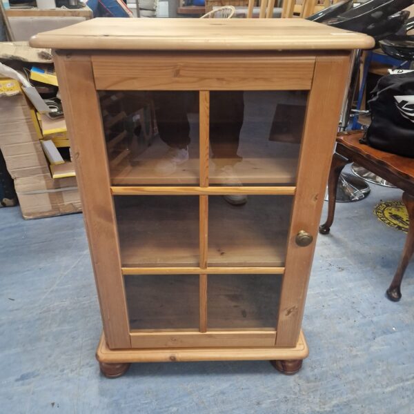 Vintage pine display cabinet with glass front for collectibles.