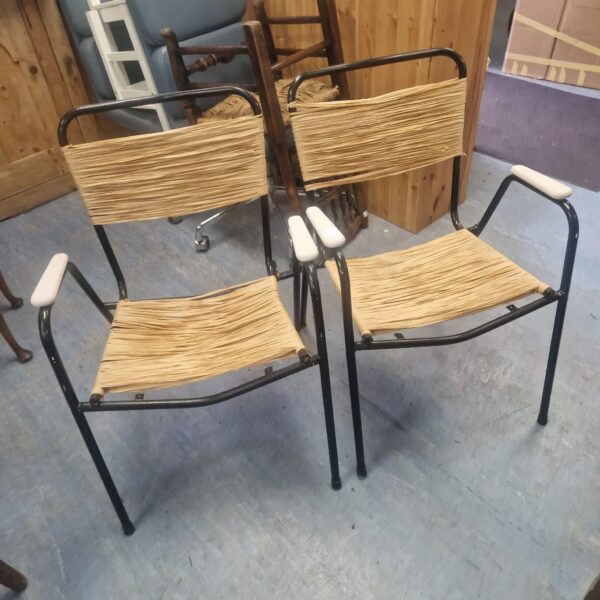 Vintage bullrush metal chairs with woven seats and backs.