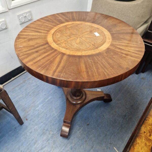 Antique Victorian mahogany flip-top table with inlaid design.