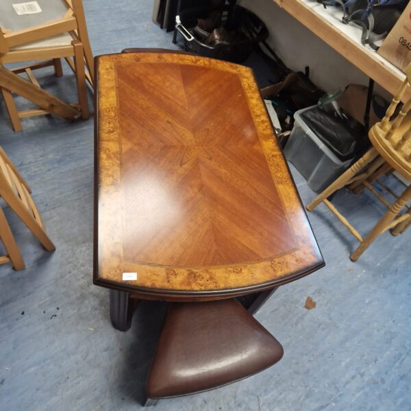 Wooden gaming coffee table with inlaid design and leather stools.