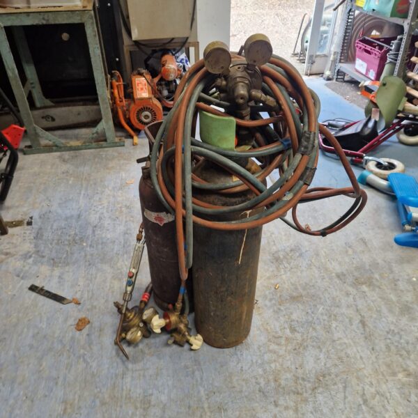 Vintage oxy acetylene kit with gas cylinders and torch.