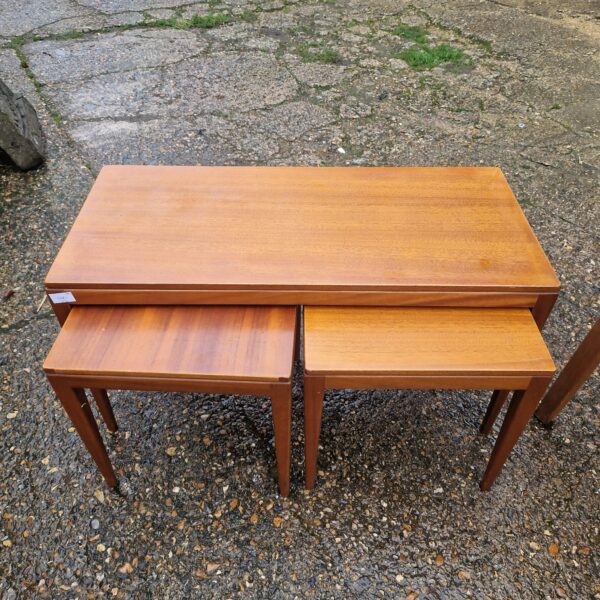 Vintage coffee table nest in warm wood, mid-century modern style.