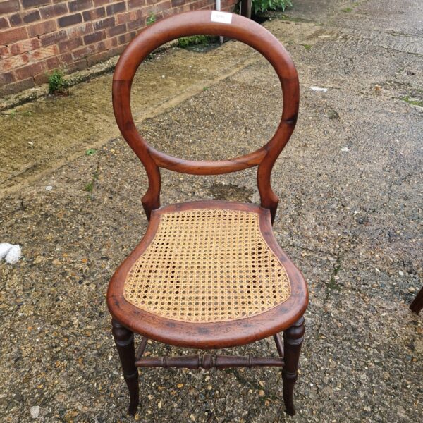 Antique cherry wood balloon back chair with woven seat.