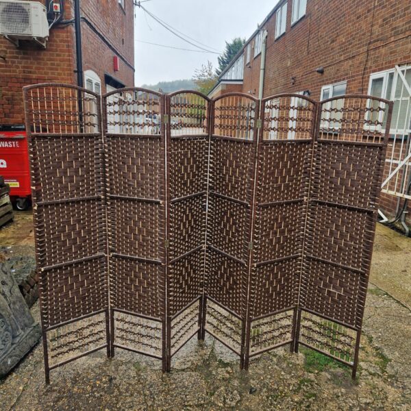 Six-fold bull rush privacy screen in a garden setting.