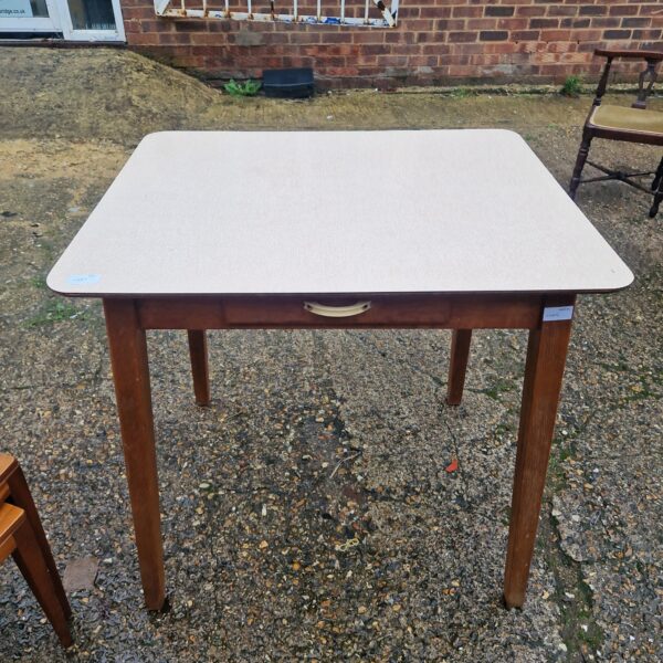 Vintage cream formica kitchen table with wooden legs.