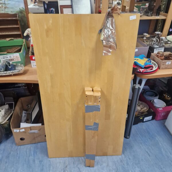 Wooden dining table top with visible grain and wear.