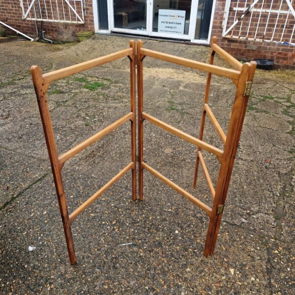 Vintage wooden clothes horse for drying laundry indoors.