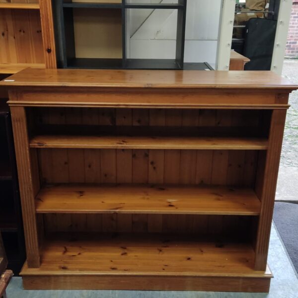 Front view of a solid pine bookshelf with open shelving.