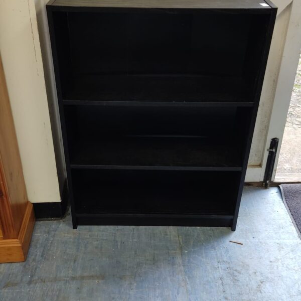 Front view of a black three-shelf book shelf.
