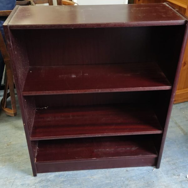 Vintage mahogany bookshelf with three shelves for books and display.