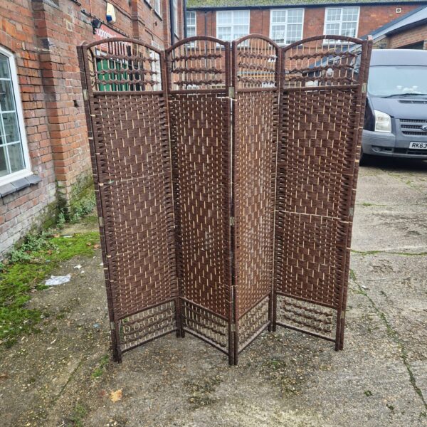Vintage folding privacy screen with woven panels.