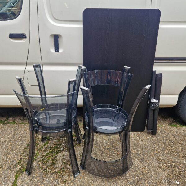 Clear perspex Ikea chairs and table set for modern dining.