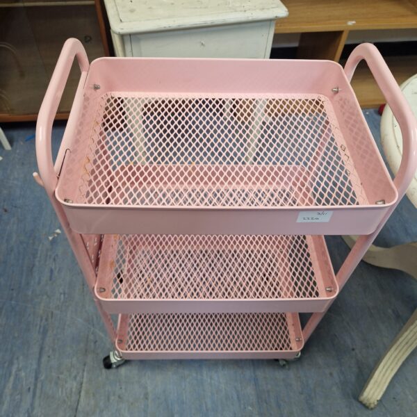 Vintage pink metal vegetable trolley with three tiers.