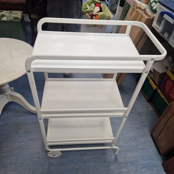 White metal serving trolley with three tiers and wheels.