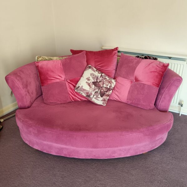 Pink DFS cuddle sofa with cushions