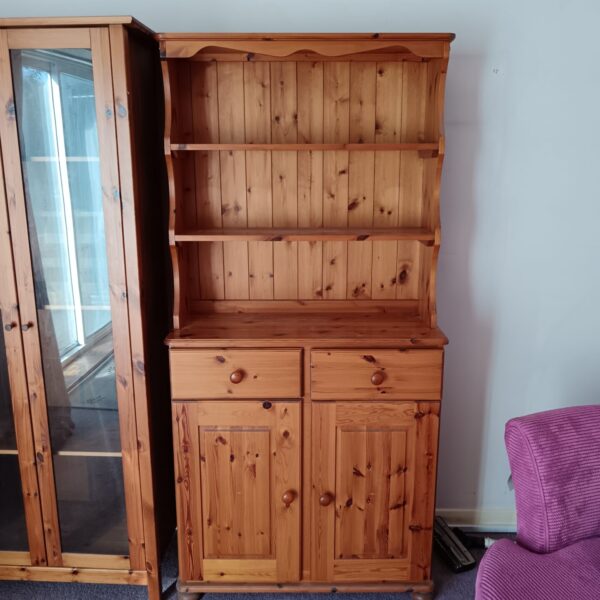 Farmhouse style pine dresser with shelving and cupboard.