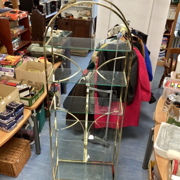 Vintage brass and glass display shelving unit for collectibles.