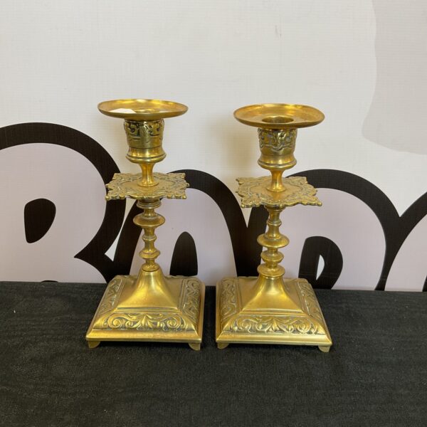 Pair of vintage brass candlesticks with ornate detailing.