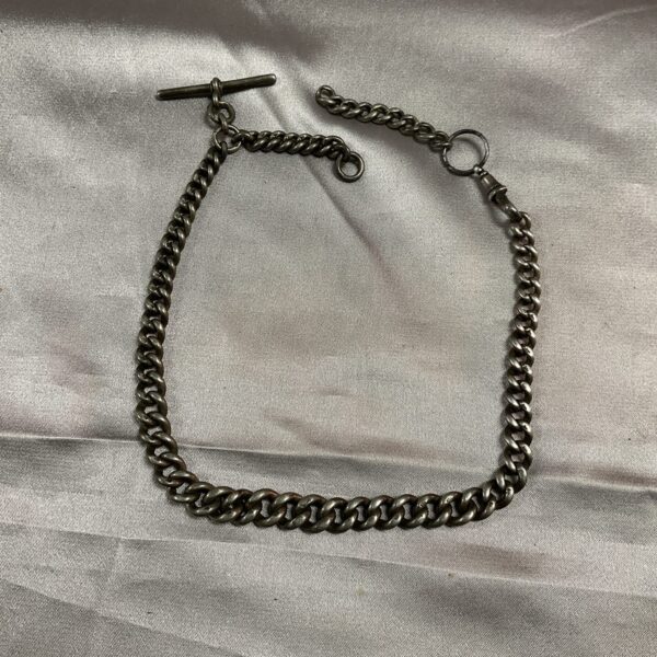 Close-up of a hallmarked silver Albert chain, antique jewellery.