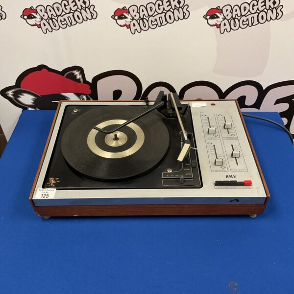 Vintage HMV record player with wooden plinth and controls.