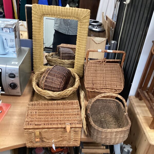 Vintage wicker collection with mirror, baskets and serving tray.