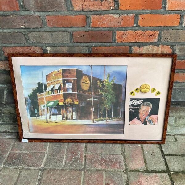 Framed Elvis Sun Studio print with accompanying memorabilia for collectors.