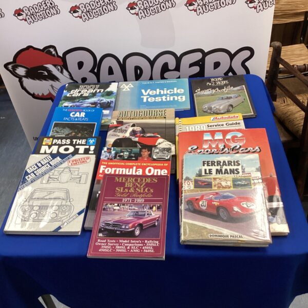 Collection of motoring books including Formula One and race car titles.