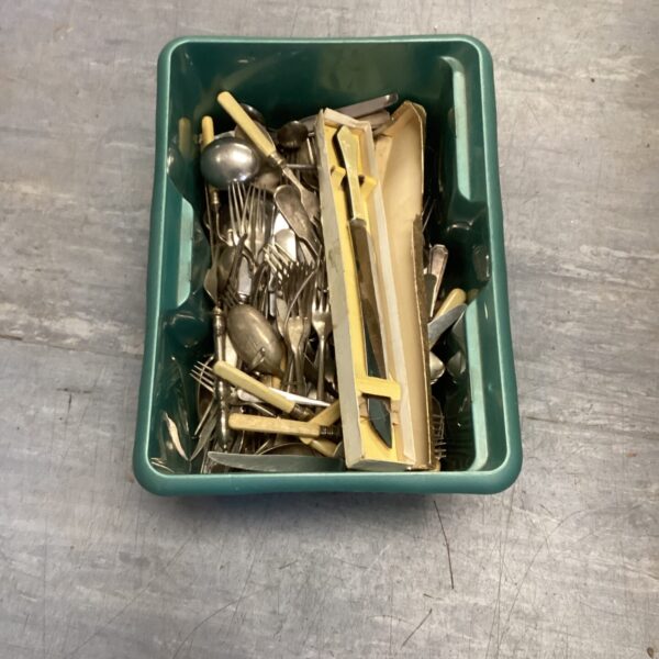 Mixed silverplate cutlery set with forks, knives, and spoons.