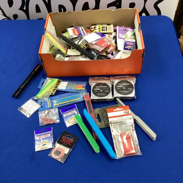 Assorted fishing accessories including pole elastic and line.