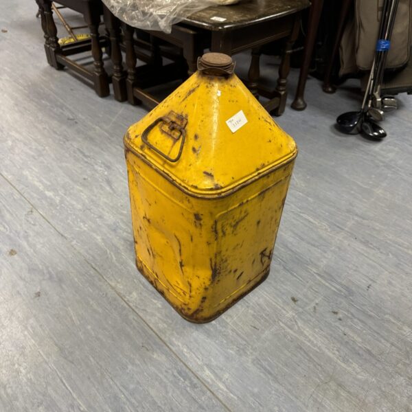 Vintage yellow metal fuel can, collectible industrial container.