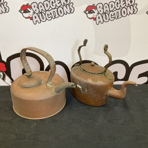 Pair of antique copper kettles with wooden handles.