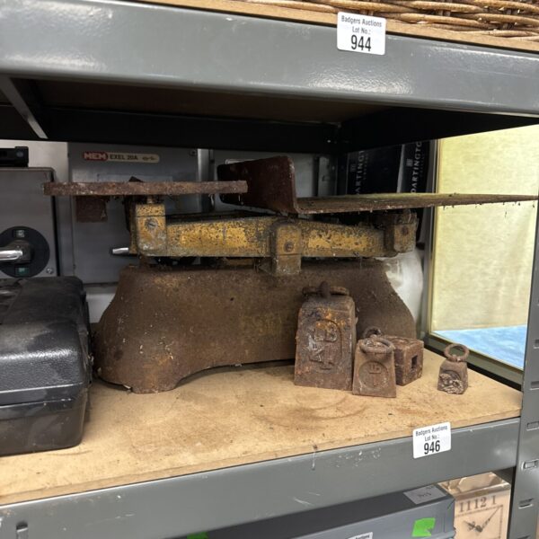 Antique balance scales with GPO weights for vintage weighing.