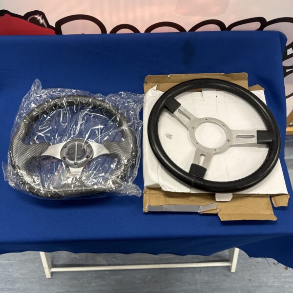 Black and silver motorsports steering wheel for racing applications.