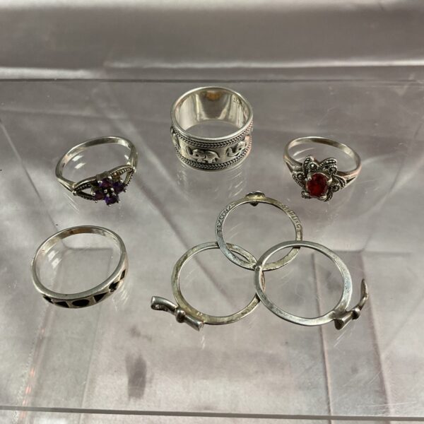 Lot of five 925 silver rings with varied stone settings.