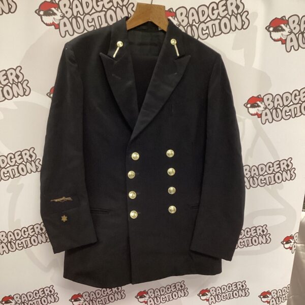 Front view of a vintage Royal Navy uniform jacket with brass buttons.