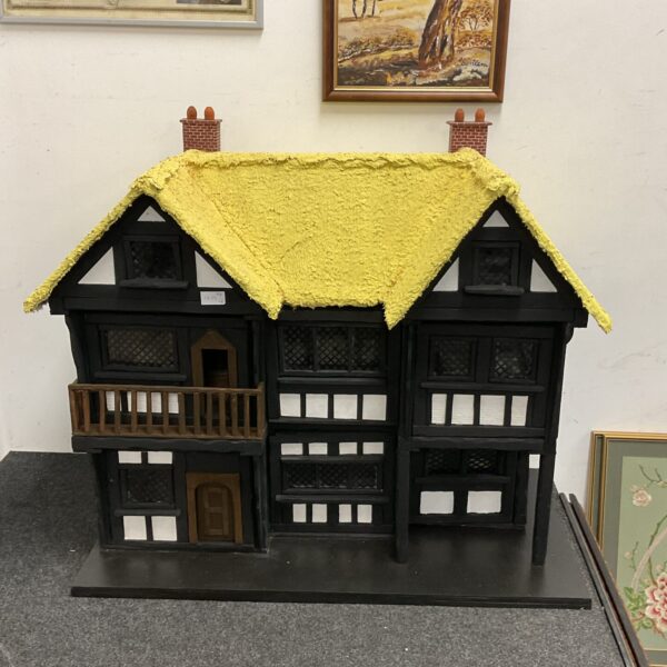 Detailed front view of a Tudor-style dolls house.