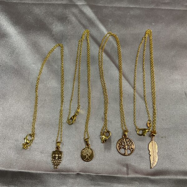 Close-up of silver gilt owl pendant necklace, dainty charm.