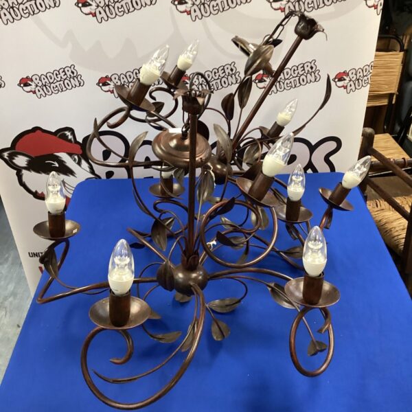 Ornate pair of metal leaf ceiling lights with detailed design.