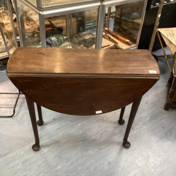 Antique George III mahogany drop leaf table with elegant legs.