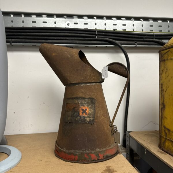 Large vintage oil can with a weathered patina.