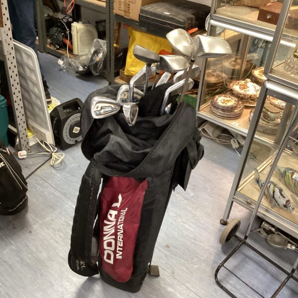 Vintage Donnay golf clubs and bag in a sports lot.