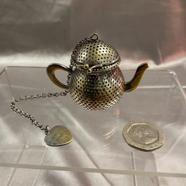 Vintage Fortnum and Mason silver plated tea strainer teapot.